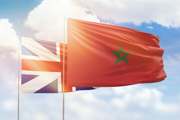 Sunny blue sky and flags of morocco and great britain