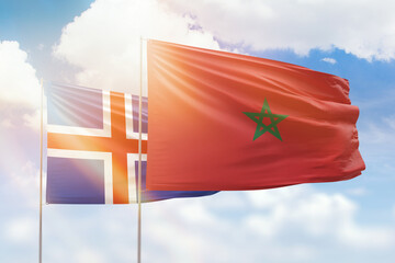 Sunny blue sky and flags of morocco and iceland