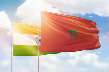 Sunny blue sky and flags of morocco and india
