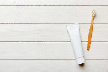 toothpaste and toothbrush top view with copy space on colored background. Flat lay. Dental hygiene. Oral care products on light background. Body care concept