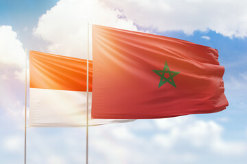 Sunny blue sky and flags of morocco and indonesia