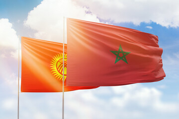 Sunny blue sky and flags of morocco and kyrgyzstan