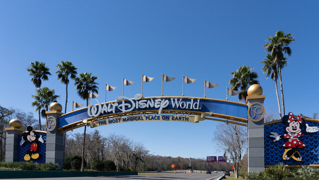 Orlando, Florida, USA - February 9, 2022:  A Walt Disney World arch gate on the road in Orlando, Florida, USA. Walt Disney World is an entertainment resort complex.