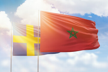 Sunny blue sky and flags of morocco and sweden