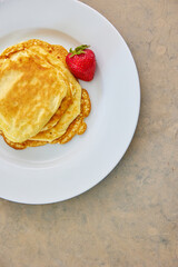 pancakes with strawberries breakfast on kitchen counter