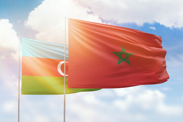 Sunny blue sky and flags of morocco and azerbaijan