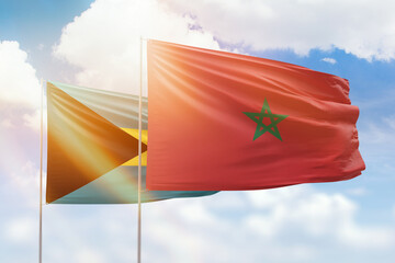 Sunny blue sky and flags of morocco and bahamas