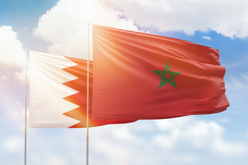 Sunny blue sky and flags of morocco and bahrain