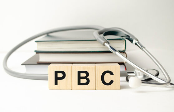 PBC Primary biliary cholangitis - word from wooden blocks with letters on wooden background