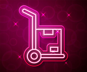 Glowing neon line Hand truck and boxes icon isolated on red background. Dolly symbol. Vector