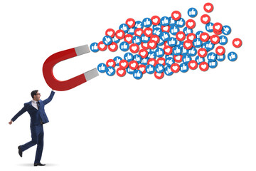 Businessman attracting likes with large magnet