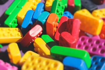 Children play colorful big toy blocks in kindergarten day care center playground, kids playing with various plastic mega construction blocks bricks