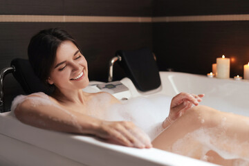 Obraz premium Happy beautiful woman taking bubble bath. Romantic atmosphere