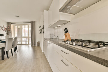 Spacious bright kitchen with white walls and tiled floor