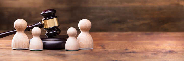 Separation Of Pawn Wooden Figure In From Of Gavel