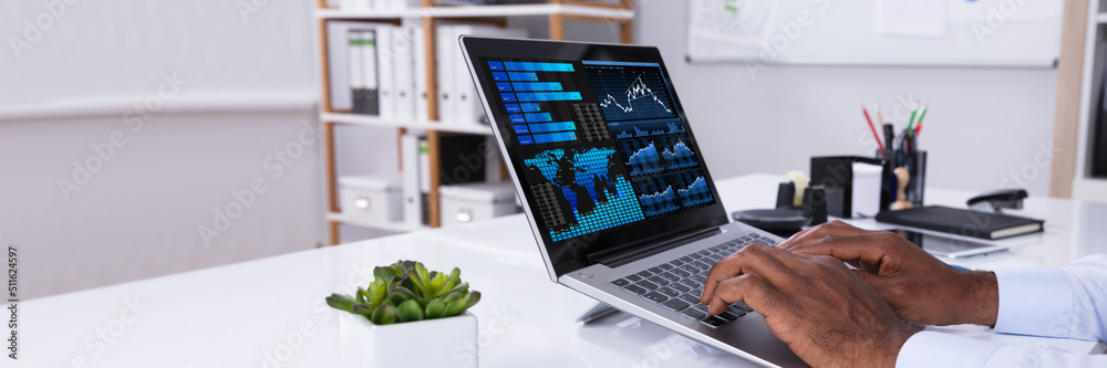 Poster man analyzing graph on laptop