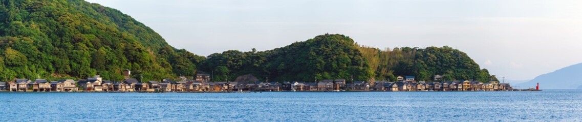 Fototapeta na wymiar Ultra wide panorama image of boathouses at Ine Town in Kyoto, Japan