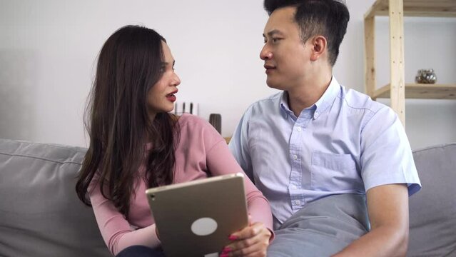 Asian couples are watching or reading the news on tablets and are shocked by some of the news they see. Couple were surprised by the news they had seen on the internet  in couple and lifestyle concept