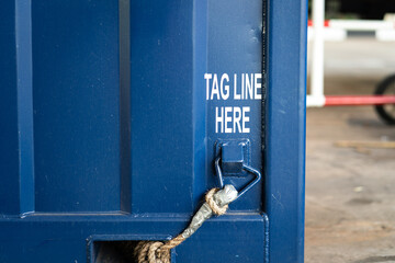 Tagline point on the heavy container box, hook up with long rope which is used to control the object when lifting without hand on load. Industrial equipment and object photo. - obrazy, fototapety, plakaty