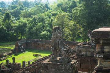 A sandstone sculpture of a lion sculpture guarding Pre Rup Castle, an ancient castle in Cambodia.