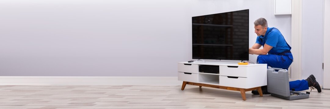 Technician Repairing Television