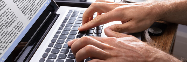 Close-up Of A Person Typing On Laptop