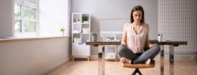 Businesswoman Meditating In Office