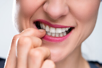 Obraz premium Businesswoman Biting Her Fingernail