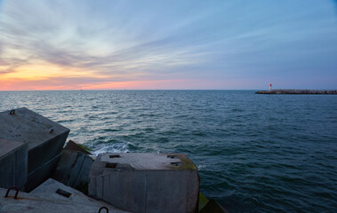 Baltic sea after the storm. Breakwaters. Dramatic sky, glowing clouds, soft sunlight, midnight sun. Picturesque dreamlike seascape, cloudscape. Nature, environment. Panoramic view © Alex Stemmer