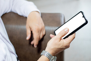A person sitting using a cell phone