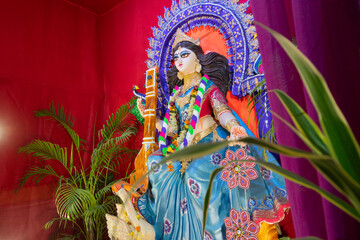 Fototapeta na wymiar Idol of Goddess Saraswati at Kolkata, West Bengal, India. Saraswati is Hindu goddess of knowledge, music, art, wisdom, and learning. Worshipping is done to get divine blessing to achieve excellence.
