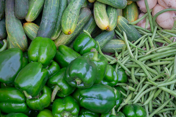 Beans, cucumber and capsicum - vegetables for sale in a market in Territy Bazar, Kolkata, West Bengal, India.
