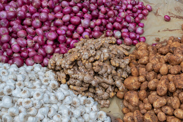 Garlic, onion, ginger and potatoes - essential vegetables for sale in a market in Territy Bazar, Kolkata, West Bengal, India.