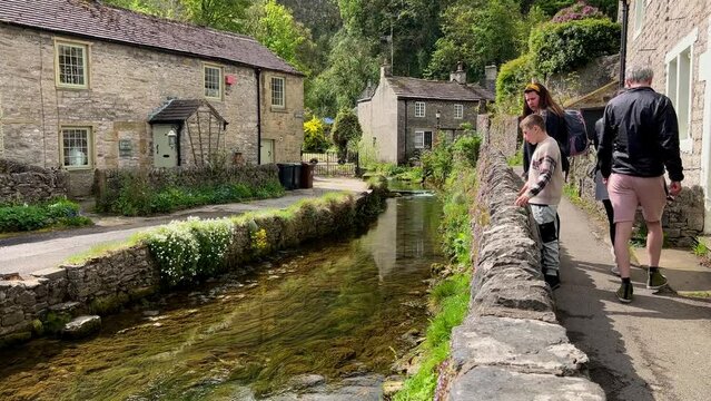 Mother and son admiring the view of Castleton Village with the river running through