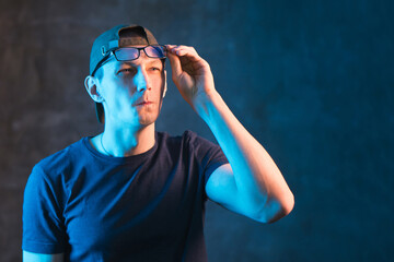 Ordinary guy in glasses makes a face. Pettiness and meticulousness concept with copy space.