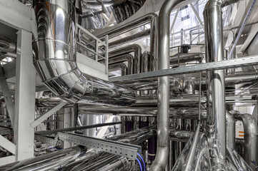 Complicated pipeline system in spacious workshop of plant