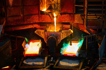 Pouring liquid copper metal for anodes into form in workshop