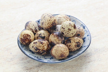 Raw quail eggs heap in the bowl