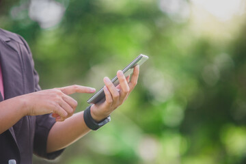 business woman Standing on the phone in the park beside the town