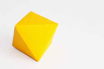 A Yellow Octahedron Rhombus on a white background