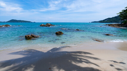 Summer sea season greeting background. Tropical sandy beach with blue ocean and blue sky background image for nature background or summer in Phuket Thailand