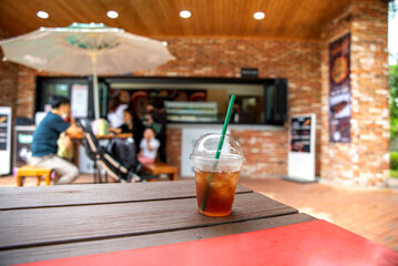 Iced americano coffee in plastic glass from Korean style street cafe.