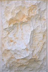Wall block texture of decorative rough sandstone panel in beige- sand-white colors . Exterior wall from natural broken stone close up photo. Building industry concept.