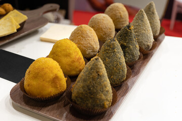 Sicilian Rice “Arancini“ displayed Row in Various Flavors, Italian Food