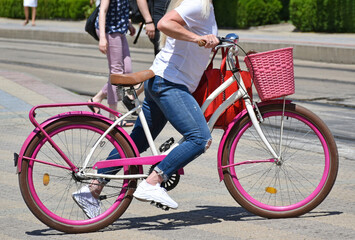 Woman with bicycle on the city street