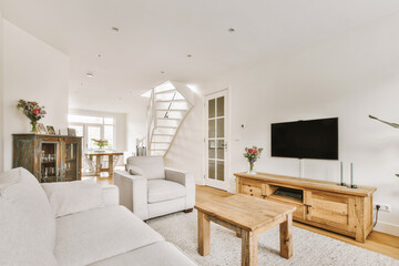 Couches and table located near TV against dining area of spacious room in contemporary apartment
