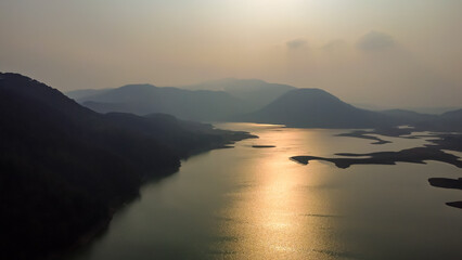 pristine lake at the edge of mountain forests aerial shots at evening