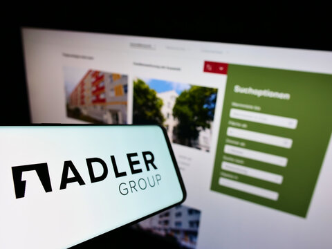 Stuttgart, Germany - 02-13-2022: Smartphone with logo of real estate company Adler Group S.A. on screen in front of business website. Focus on center-left of phone display.