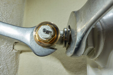 Stuttgart, Germany - February 01, 2022: Install Heimeier thermostat valve. Open-end wrench screws component to the old radiator. Modernize heating systems. - obrazy, fototapety, plakaty