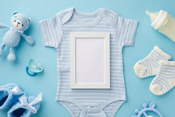 Baby accessories concept. Top view photo of photo frame blue bodysuit socks knitted teddy-bear toy...